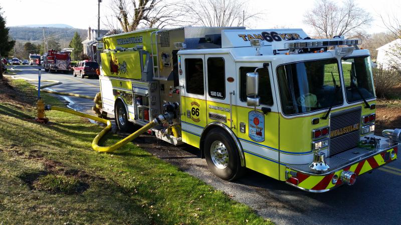 Tanker 66 Supplying water to a house fire on 4/11/15. Photo by J. Albert