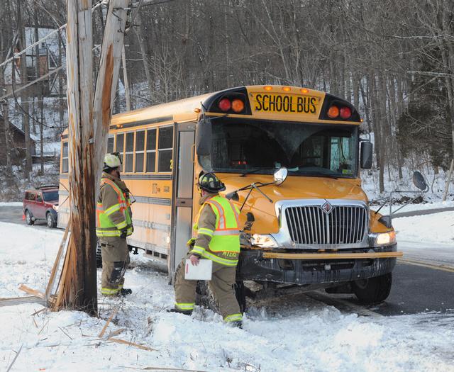 School bus slides into telephone pole.  photos by Curt Werner