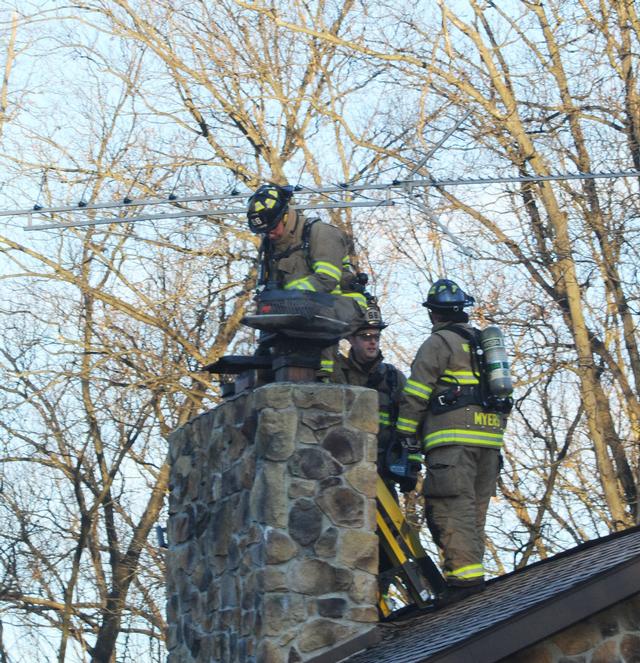 Chimney fire on Christmas morning.  Eighteen degrees.  Photos by Curt Werner