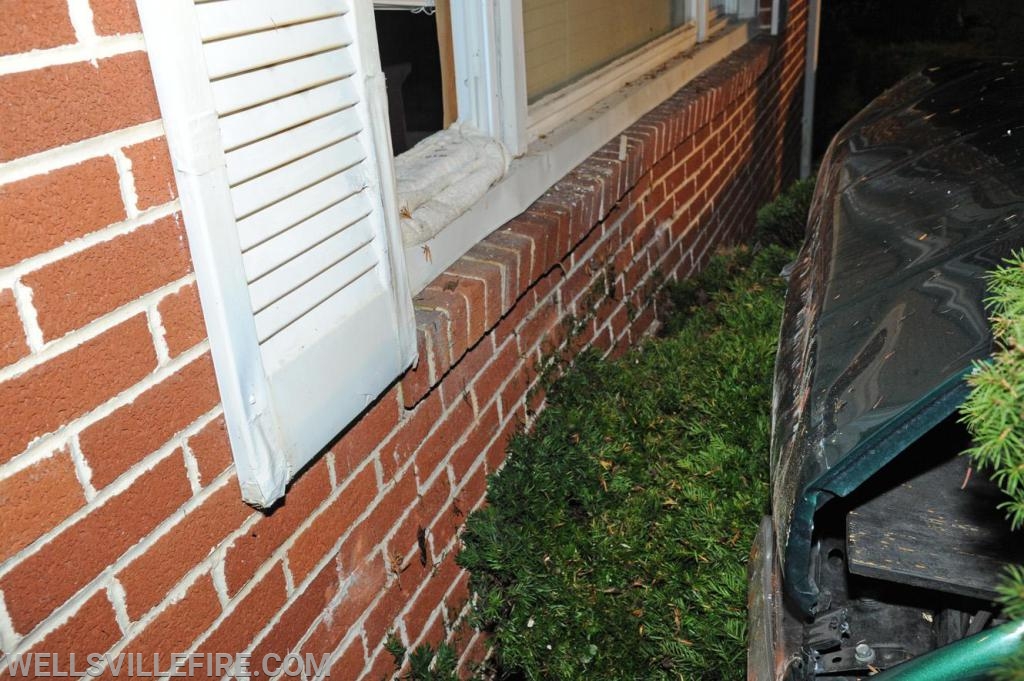 Friday night, August 23, vehicle into house on Wellsville Road.  photos by curt werner
