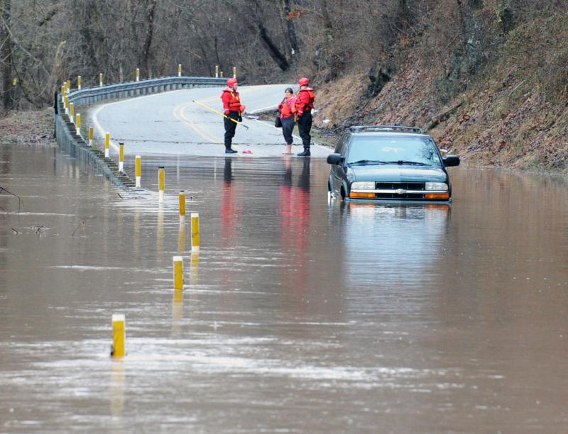 Wellsville water rescue Nyck Fair and Jake Albert stand with a woman rescued from her car that was driven into high waters on Detters Mill Road, Warrington Township on Thursday morning, 7:12 a.m., February 25.
