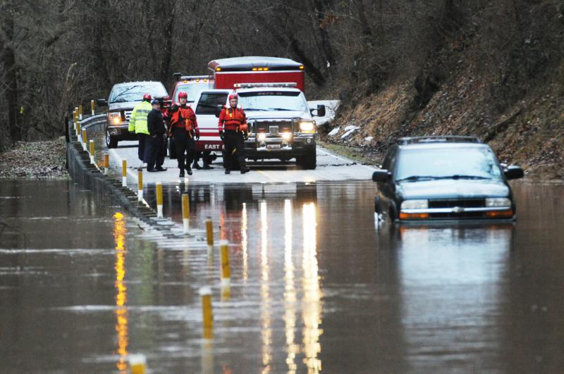 Wellsville water rescue Nyck Fair and Jake Albert stand with a woman rescued from her car that was driven into high waters on Detters Mill Road, Warrington Township on Thursday morning, 7:12 a.m., February 25.