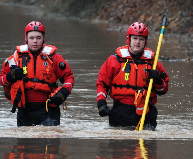 Wellsville water rescue Nyck Fair and Jake Albert stand with a woman rescued from her car that was driven into high waters on Detters Mill Road, Warrington Township on Thursday morning, 7:12 a.m., February 25.