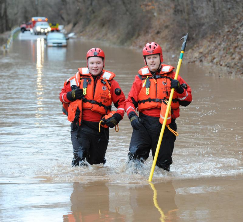 Wellsville water rescue Nyck Fair and Jake Albert stand with a woman rescued from her car that was driven into high waters on Detters Mill Road, Warrington Township on Thursday morning, 7:12 a.m., February 25.