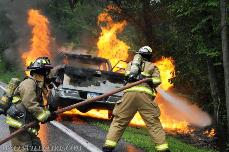 On Wednesday, June 15, a pickup truck caught on fire of Alpine Road.  Craig Harlacker and Alexus Kaylor worked the hose.  photo by curt werner
