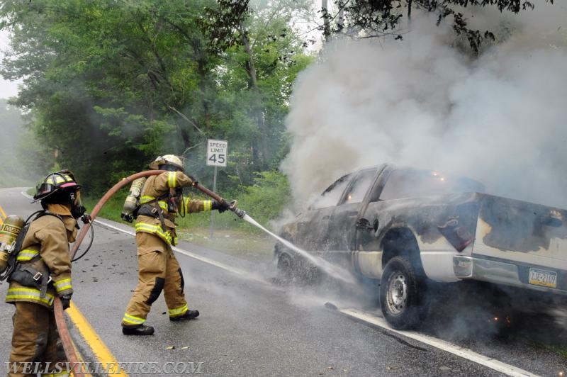 On Wednesday, June 15, a pickup truck caught on fire of Alpine Road.  Craig Harlacker and Alexus Kaylor worked the hose.  photo by curt werner