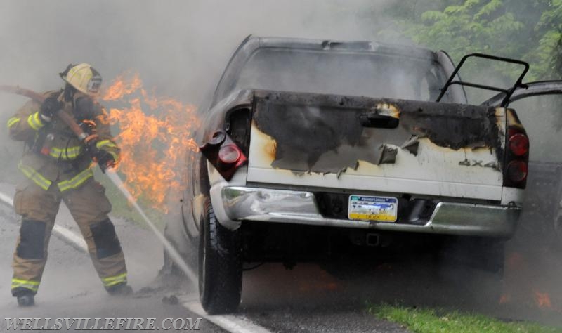 On Wednesday, June 15, a pickup truck caught on fire of Alpine Road.  Craig Harlacker and Alexus Kaylor worked the hose.  photo by curt werner