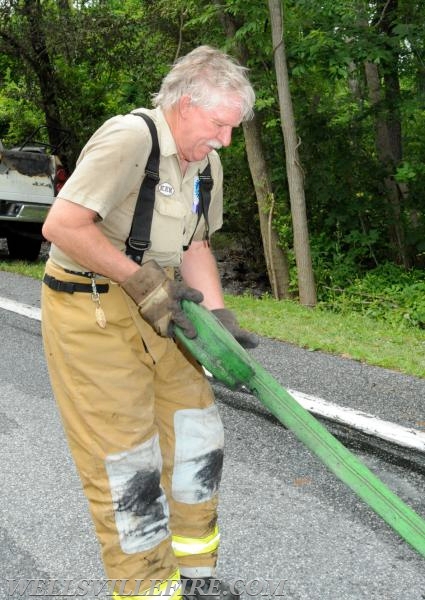 On Wednesday, June 15, a pickup truck caught on fire of Alpine Road.  Craig Harlacker and Alexus Kaylor worked the hose.  photo by curt werner