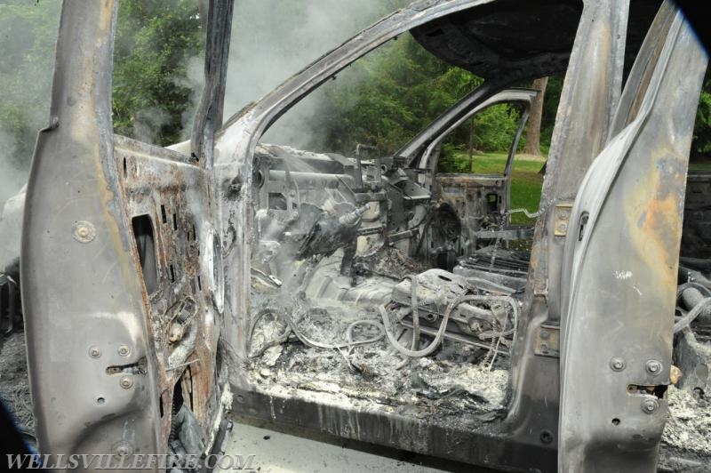 On Wednesday, June 15, a pickup truck caught on fire of Alpine Road.  Craig Harlacker and Alexus Kaylor worked the hose.  photo by curt werner