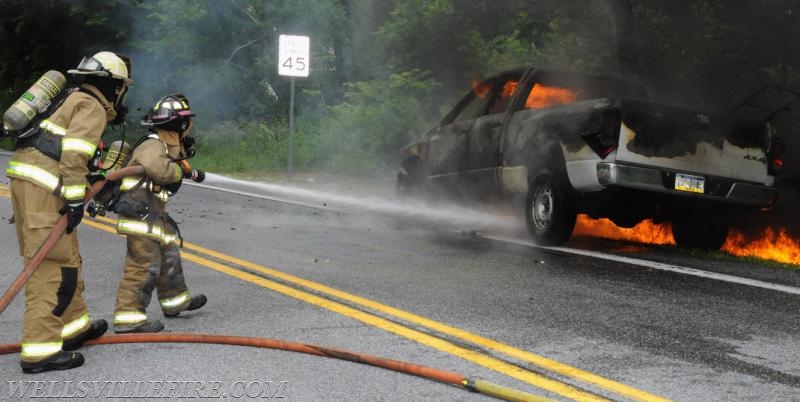 On Wednesday, June 15, a pickup truck caught on fire of Alpine Road.  Craig Harlacker and Alexus Kaylor worked the hose.  photo by curt werner