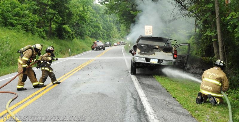 On Wednesday, June 15, a pickup truck caught on fire of Alpine Road.  Craig Harlacker and Alexus Kaylor worked the hose.  photo by curt werner