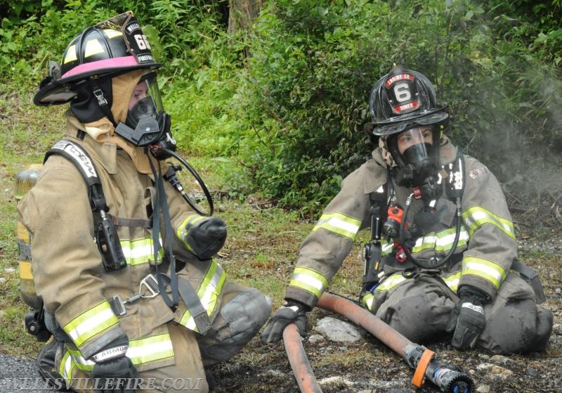 On Wednesday, June 15, a pickup truck caught on fire of Alpine Road.  Craig Harlacker and Alexus Kaylor worked the hose.  photo by curt werner