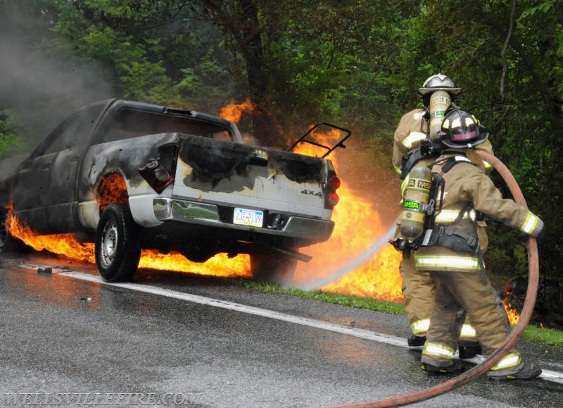 On Wednesday, June 15, a pickup truck caught on fire of Alpine Road.  Craig Harlacker and Alexus Kaylor worked the hose.  photo by curt werner