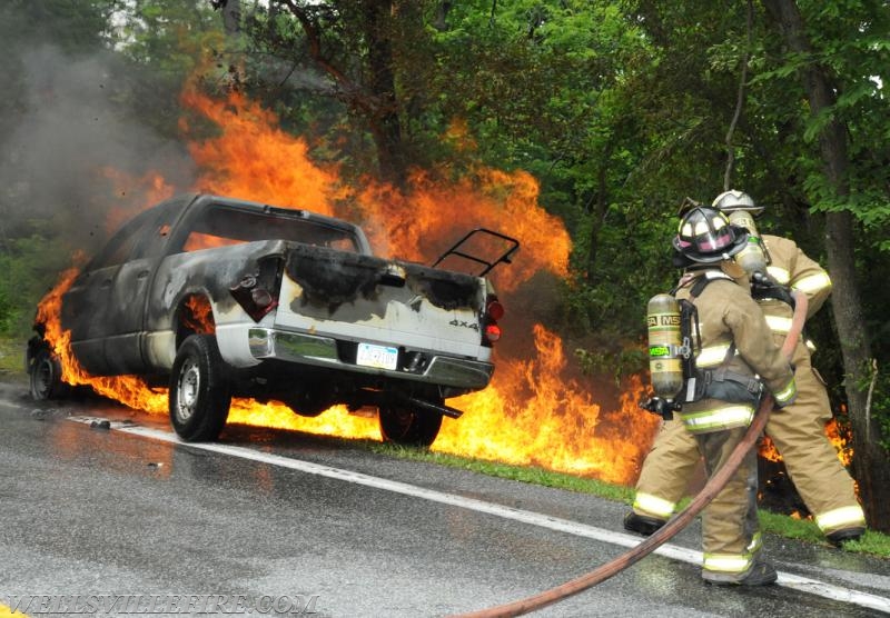 On Wednesday, June 15, a pickup truck caught on fire of Alpine Road.  Craig Harlacker and Alexus Kaylor worked the hose.  photo by curt werner