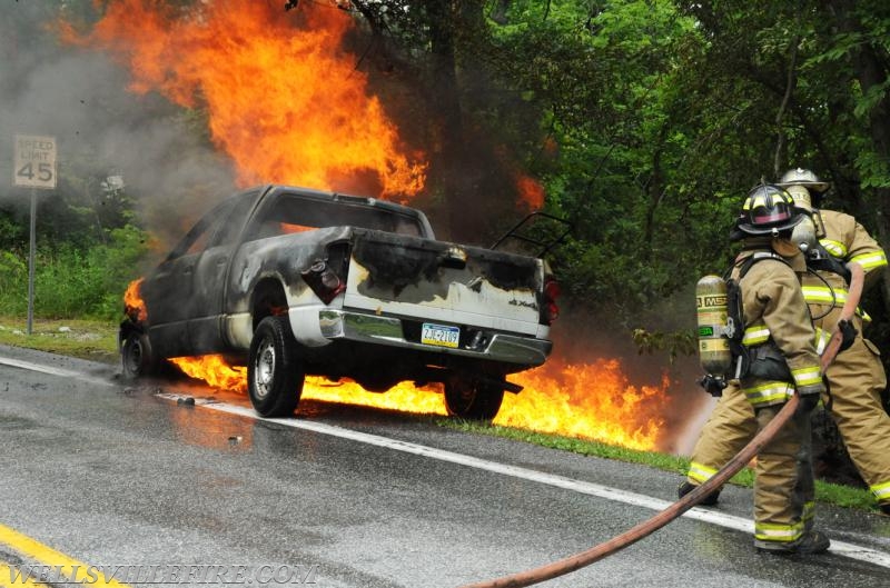 On Wednesday, June 15, a pickup truck caught on fire of Alpine Road.  Craig Harlacker and Alexus Kaylor worked the hose.  photo by curt werner