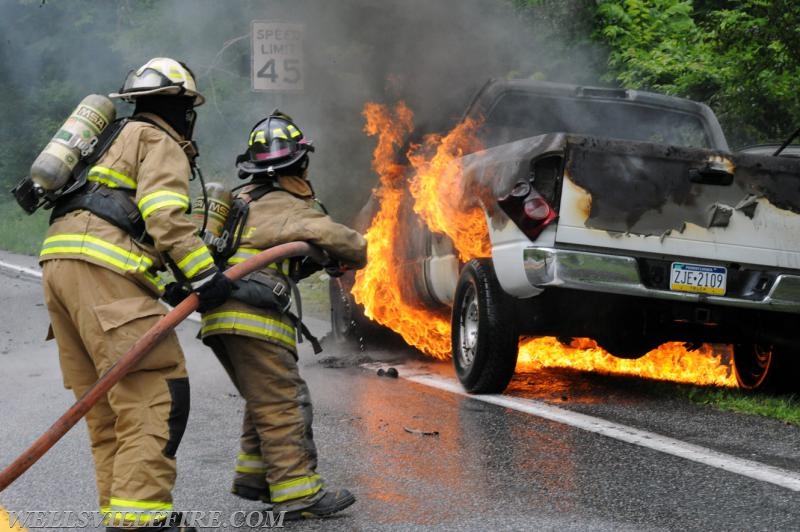 On Wednesday, June 15, a pickup truck caught on fire of Alpine Road.  Craig Harlacker and Alexus Kaylor worked the hose.  photo by curt werner