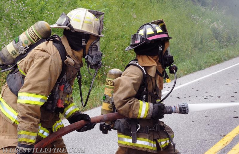 On Wednesday, June 15, a pickup truck caught on fire of Alpine Road.  Craig Harlacker and Alexus Kaylor worked the hose.  photo by curt werner