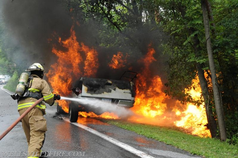 On Wednesday, June 15, a pickup truck caught on fire of Alpine Road.  Craig Harlacker and Alexus Kaylor worked the hose.  photo by curt werner