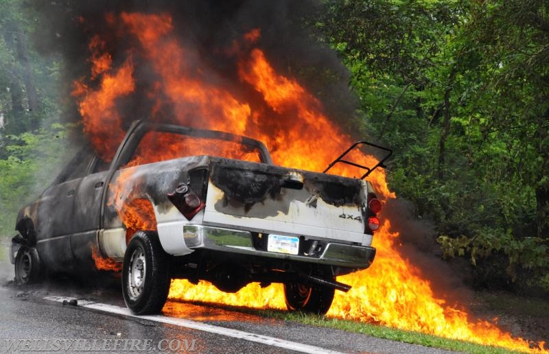 On Wednesday, June 15, a pickup truck caught on fire of Alpine Road.  Craig Harlacker and Alexus Kaylor worked the hose.  photo by curt werner