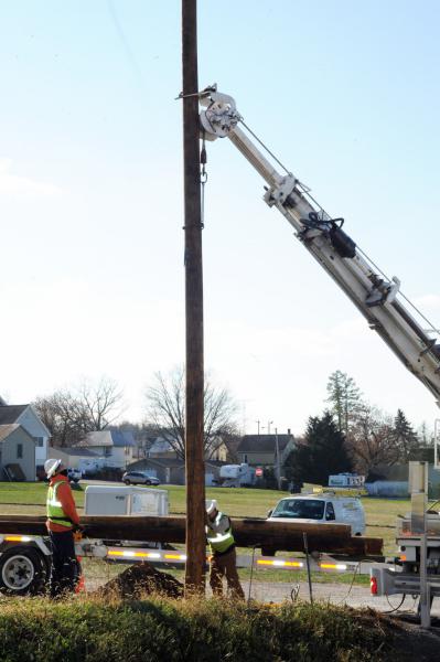 On Friday, November 21,  Adams Electric and volunteers put up telephone poles and under ground wiring for the new lightning.
