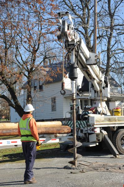 On Friday, November 21,  Adams Electric and volunteers put up telephone poles and under ground wiring for the new lightning. photos by curt werner